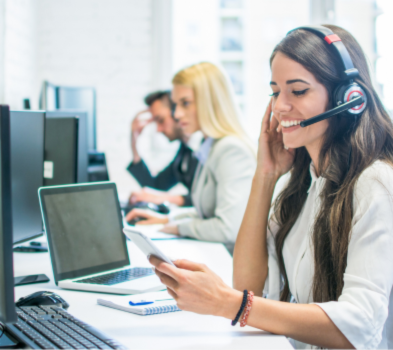 You’re On Assignment—And We’ve Got Your Back A woman wearing a headset, engaged in a conversation on the phone, focused and attentive.